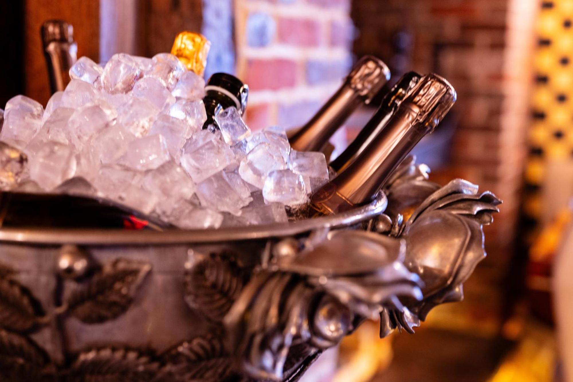 Crazy Bear Beaconsfield Hotel Exterior photo Champagne bottles in a champagne bucket